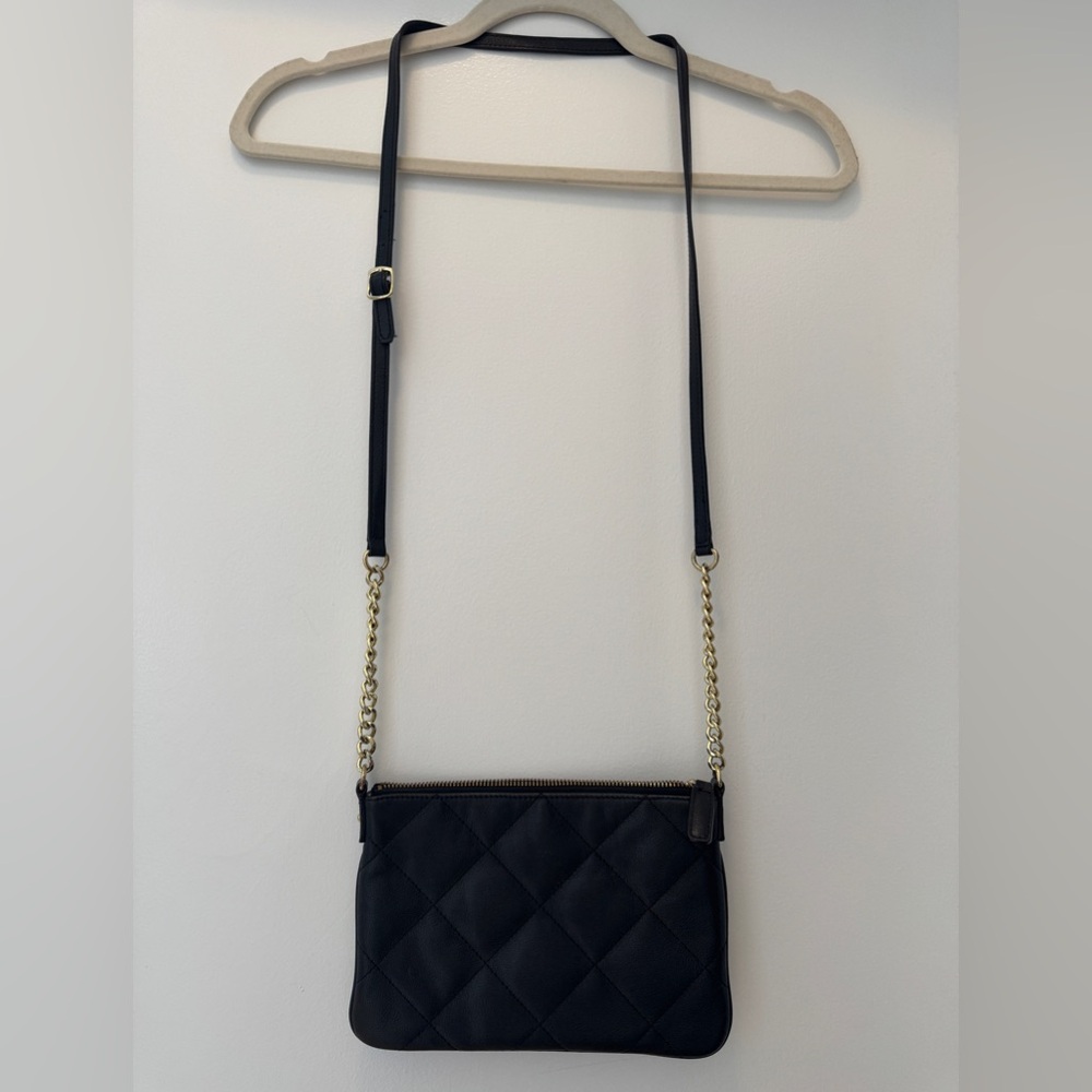 Black quilted crossbody bag with gold chain accents